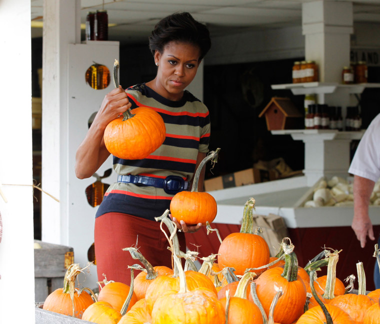 Image: U.S. first lady Michelle Obama picks Halloween pumpkins along with her husband U.S. President Barack Obama at Wood's Orchard in Hampton